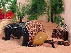 A sexy lady in latex and rubber clothing enjoys some inflatable fun with her son