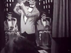 Vintage babe with big boobs dances seductively on stage for vintage erotic filming