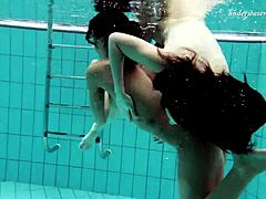 Two European solo girls enjoy a nude swim in the pool