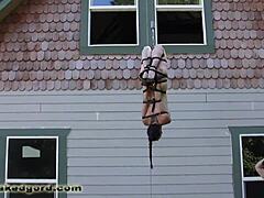 Bound and gagged submissive hanging from straps